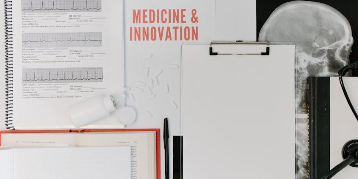 Flat lay of medical documents and equipment emphasizing innovation.